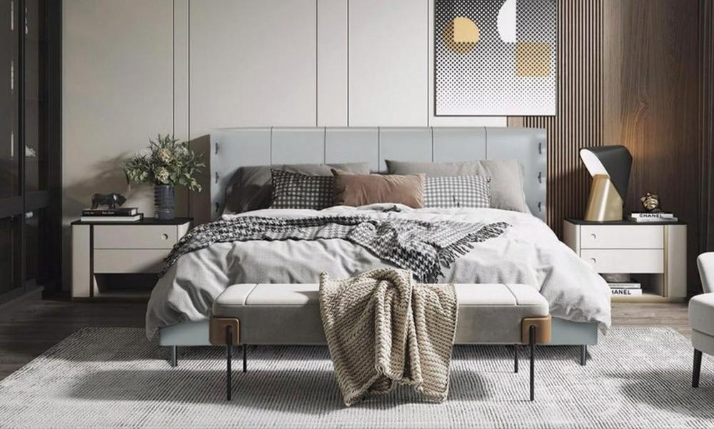 Pale grey upholstered bed with a shell-shaped headboard and a bench at the foot
